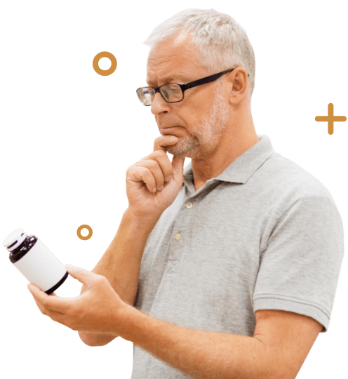Man thinking while holding a pill bottle