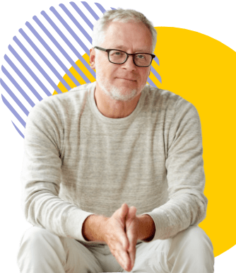 Aged man in glasses sitting down, confident and satisfied