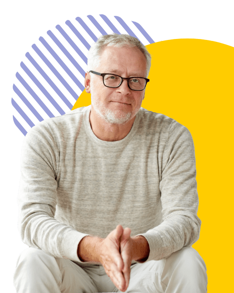 Aged man in glasses sitting down, confident and satisfied